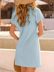 Sky blue waffle knit dress with short sleeves and lace detail, styled with a straw hat.