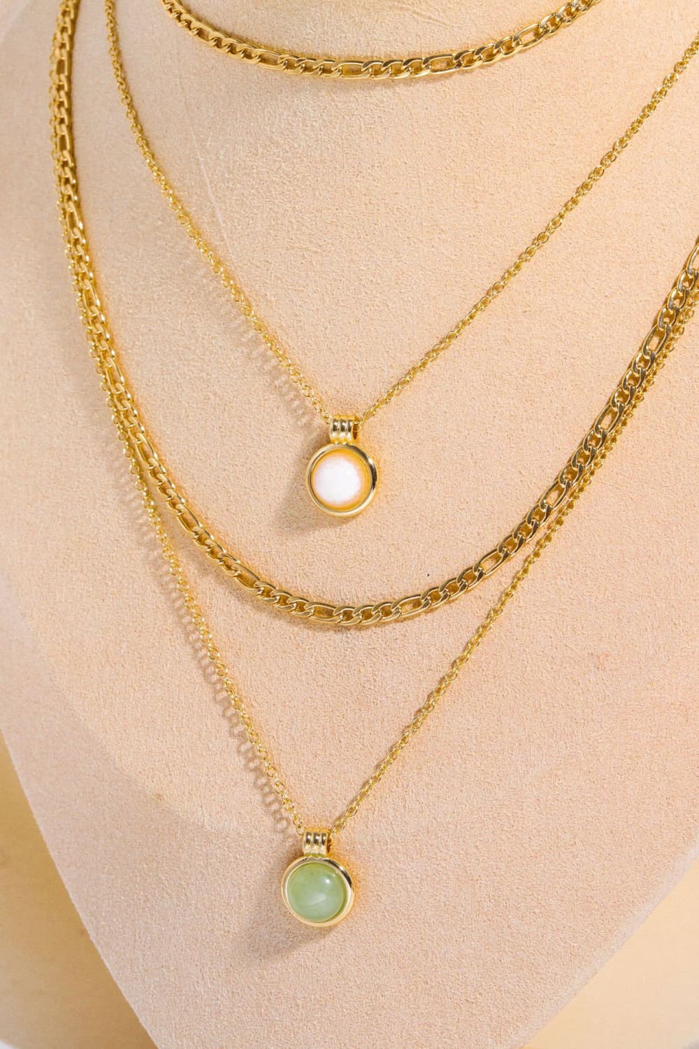 Gold layered necklaces with green aventurine and white orb pendants