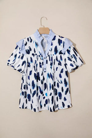 Vibrant abstract print polyester shirt with ruffled sleeves, V-neck and buttoned front.