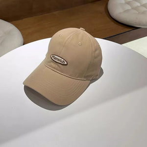 Tan baseball cap with embroidered oval logo detail