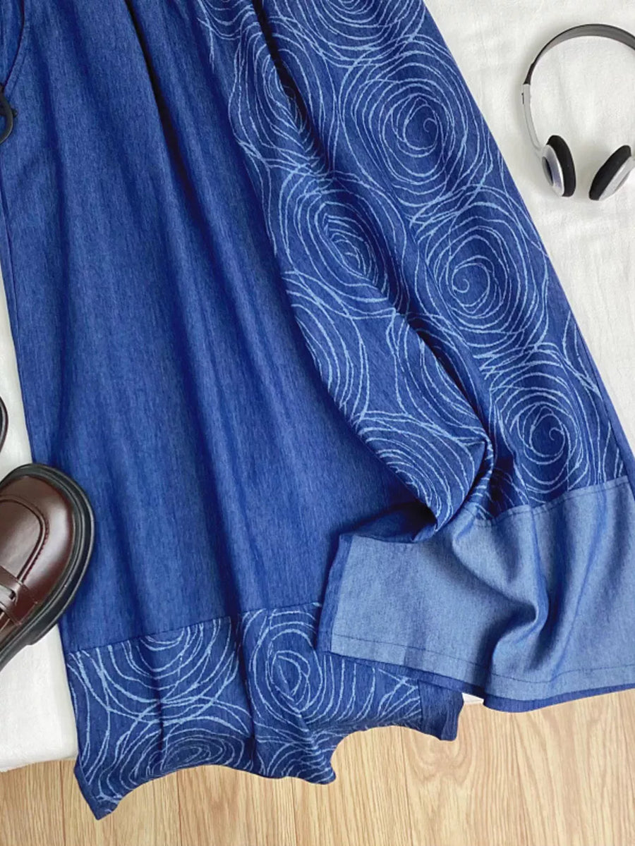 Blue denim jeans with a rose print pattern and drawstring waist.