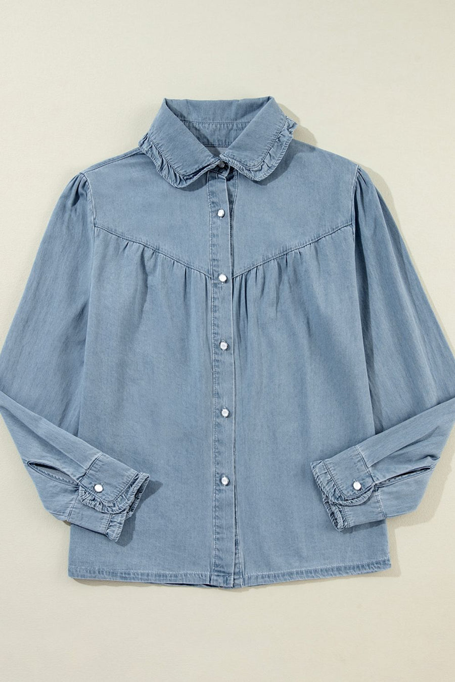 Indigo Dreams button-up blouse in medium blue denim with ruffled collar and cuffs.