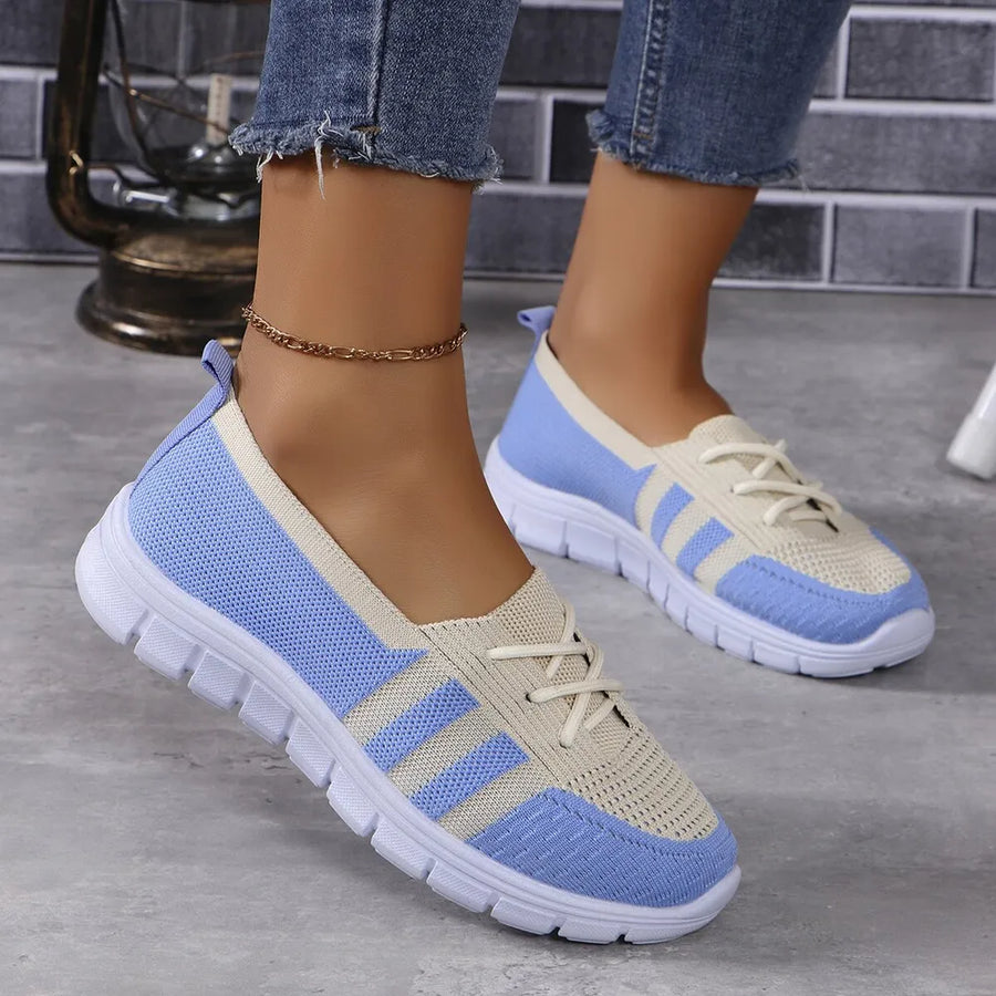 Breathable knit lace-up sneakers in blue and beige with striped accents.