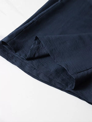 Navy blue linen blend wide leg pants with a crinkled texture and elastic waistband.