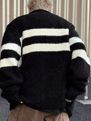 Black and white striped knit cardigan with a textured finish and relaxed fit.