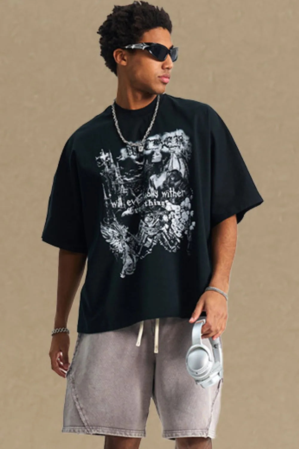 Black oversized graphic tee with gothic print and short sleeves.