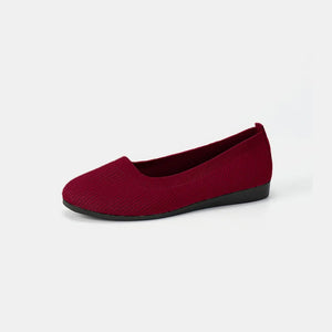 Burgundy textured knit slip-on flats with a rounded toe and black sole.