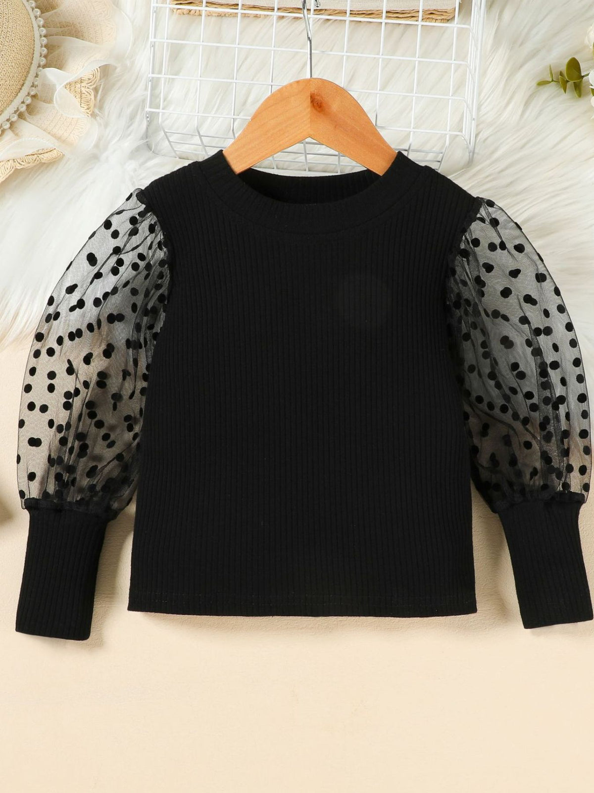 Black toddler top with polka dot sheer puff sleeves and ribbed body.