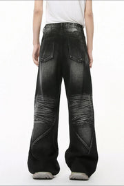 Dark wash wide leg denim jeans with textured knees and a relaxed fit.