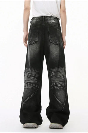 Dark wash wide leg denim jeans with textured knees and a relaxed fit.
