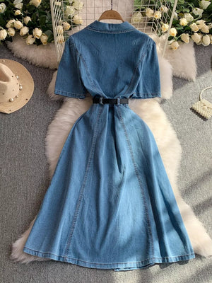Light blue collared denim dress with short sleeves, belted waist, and flared skirt.