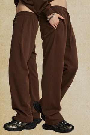 Relaxed fit brown joggers with drawstring waist and pockets.