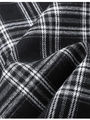 Men's black and white plaid button-up shirt detail, cotton blend fabric texture.