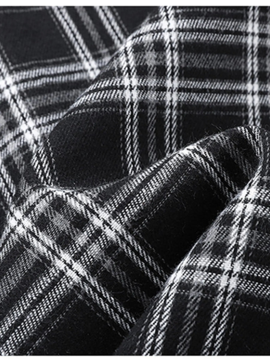 Men's black and white plaid button-up shirt detail, cotton blend fabric texture.