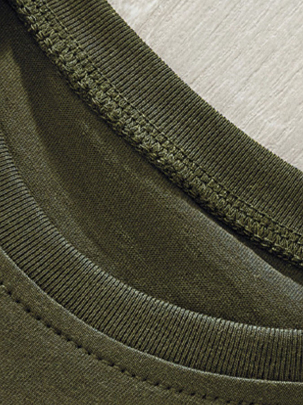 Toddler green crew neck t-shirt detail showing ribbed neckline and stitching.