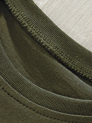Toddler green crew neck t-shirt detail showing ribbed neckline and stitching.