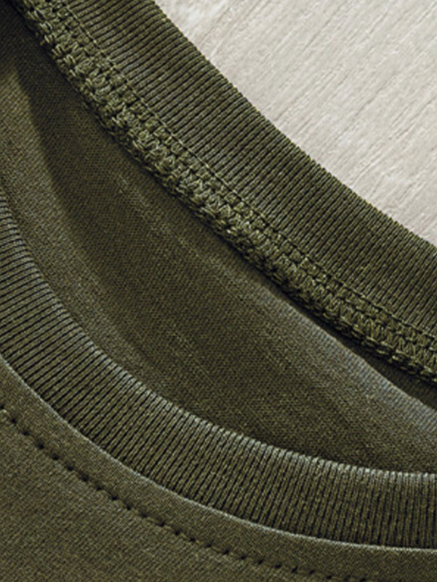 Toddler green crew neck t-shirt detail showing ribbed neckline and stitching.