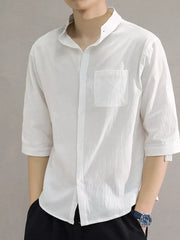 White cotton button-down shirt with roll-up sleeves and chest pocket