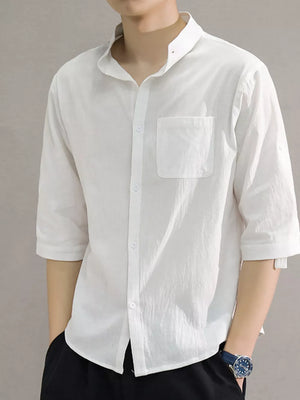 White cotton button-down shirt with roll-up sleeves and chest pocket