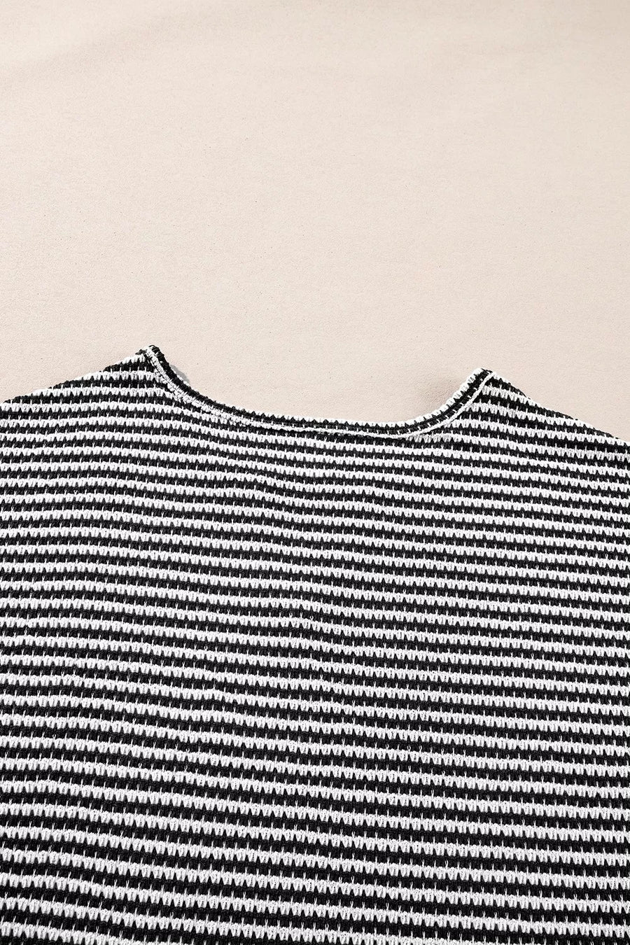 Textured knit t-shirt with a notched neckline and black and white horizontal stripes.