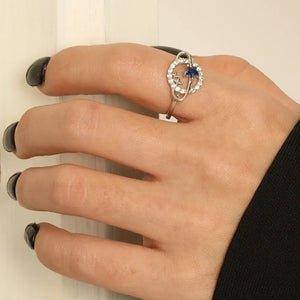 Silver ring with blue zircon and star details on a hand