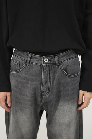 Faded dark gray cotton denim jeans with a wide-leg silhouette and classic five-pocket styling.