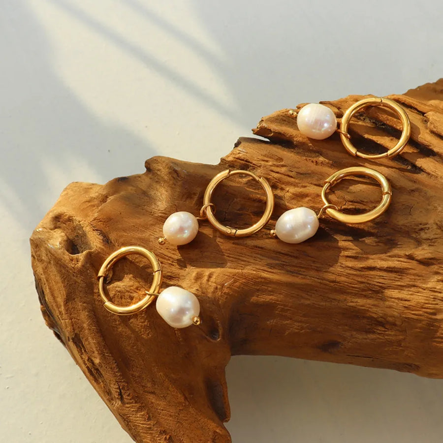 Gold hoop earrings with lustrous pearl drops
