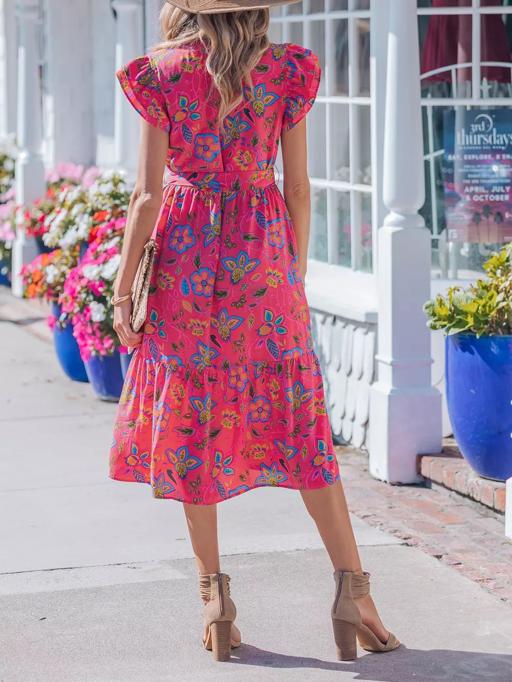 Floral midi dress with ruffled sleeves, belted waist, and tiered hem in a cotton blend.