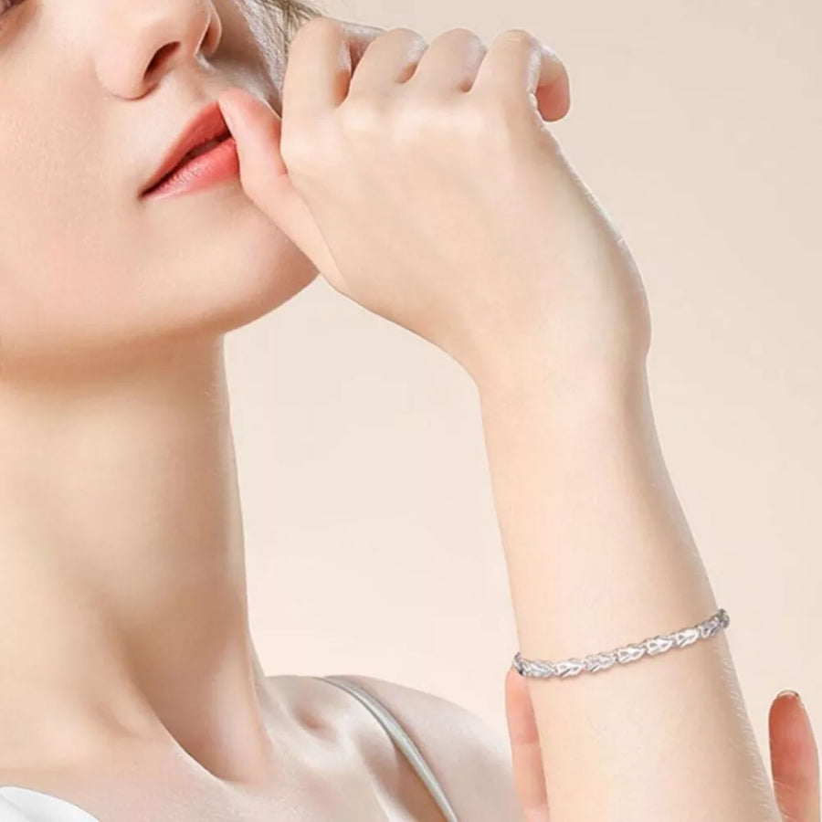 Sterling silver bracelet with interconnected heart links on a woman's wrist
