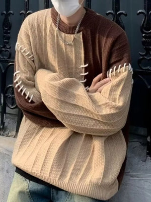 Oversized color block sweater in brown and beige with unique white stitching detail on sleeves.