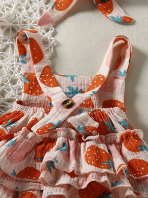 Baby bodysuit with strawberry print, ruffle details, and a button accent. Includes matching headband.