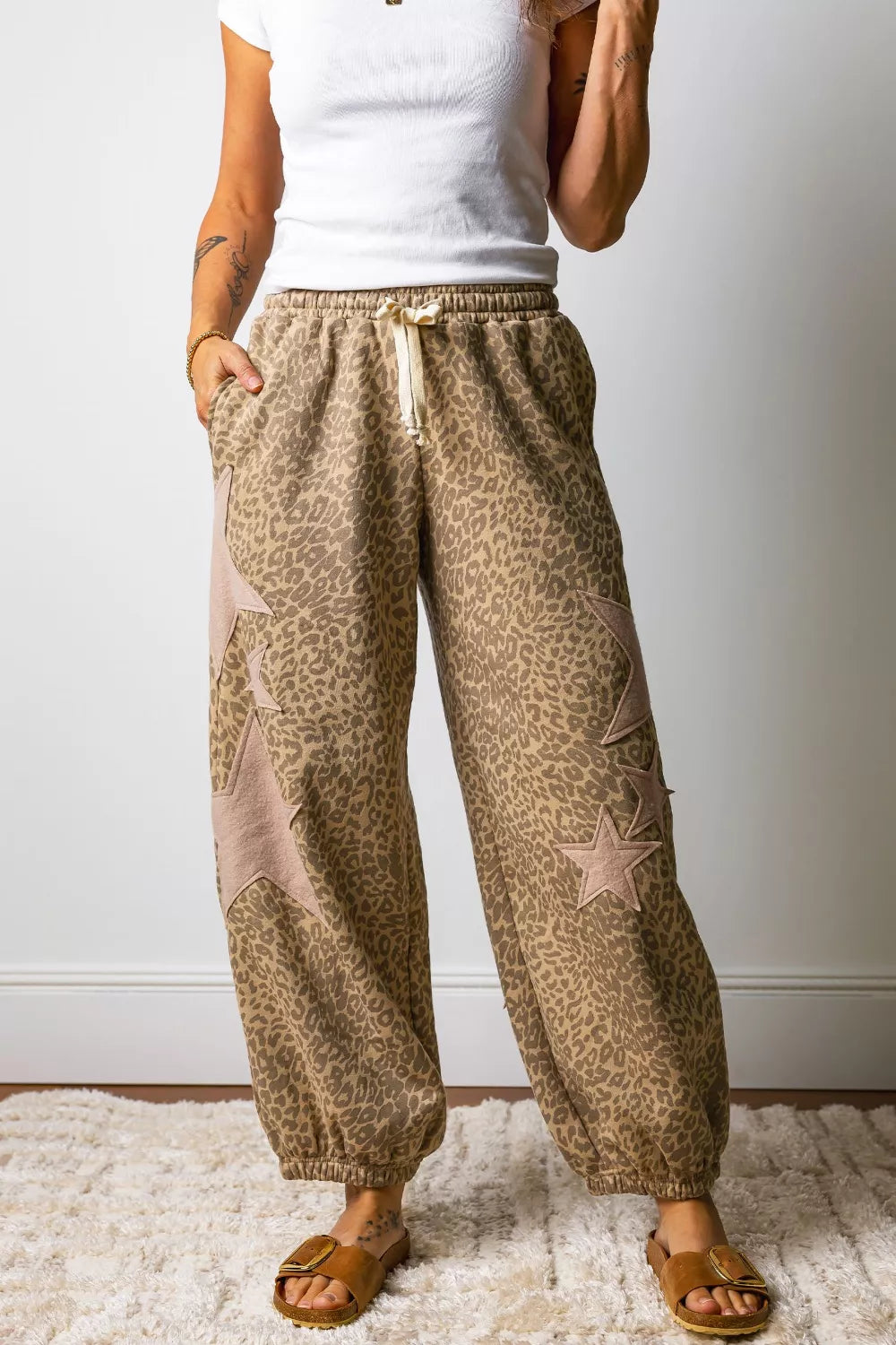 Leopard print relaxed fit pants with star patches and drawstring waist