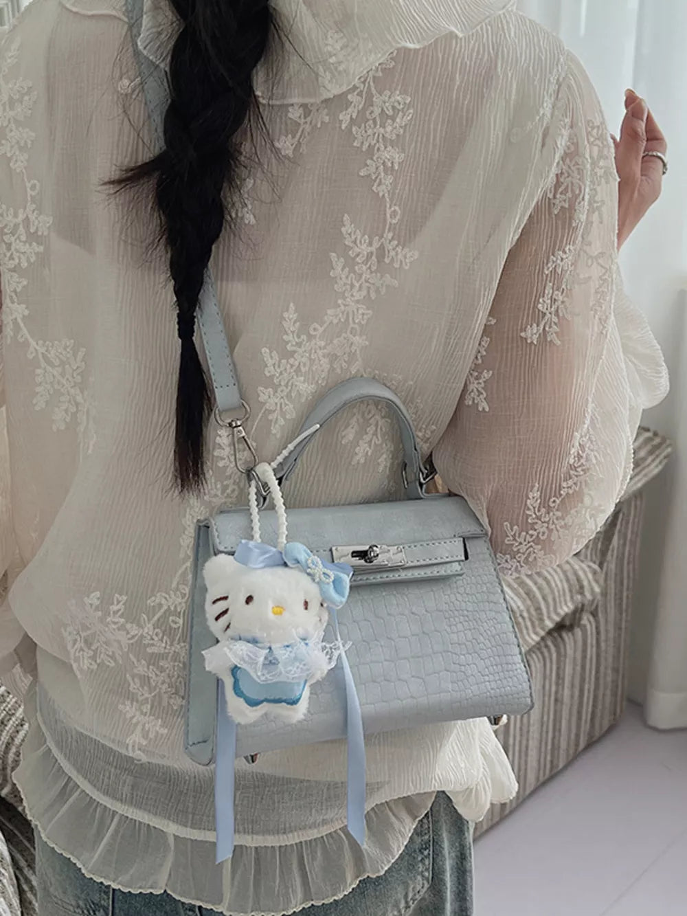 Pastel blue croc-embossed mini crossbody bag with Hello Kitty charm