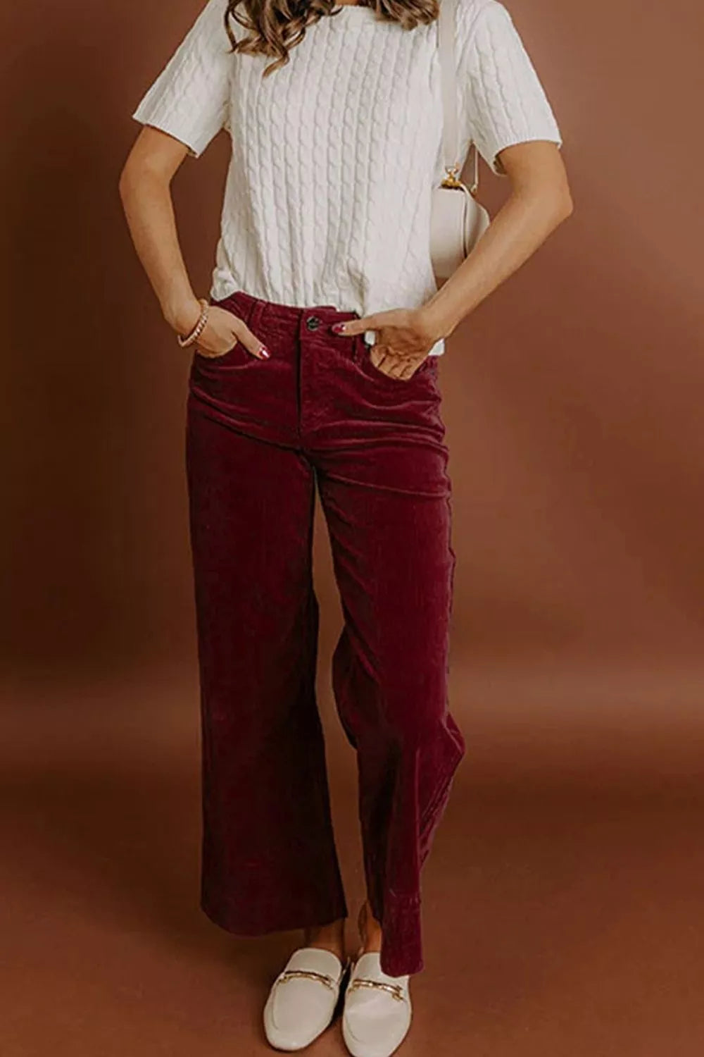 wide-leg pants in burgundy featuring high-waisted and flared fit