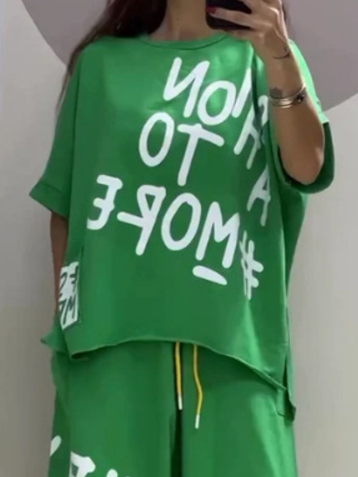 Green graphic tee with white text and drawstring pants set
