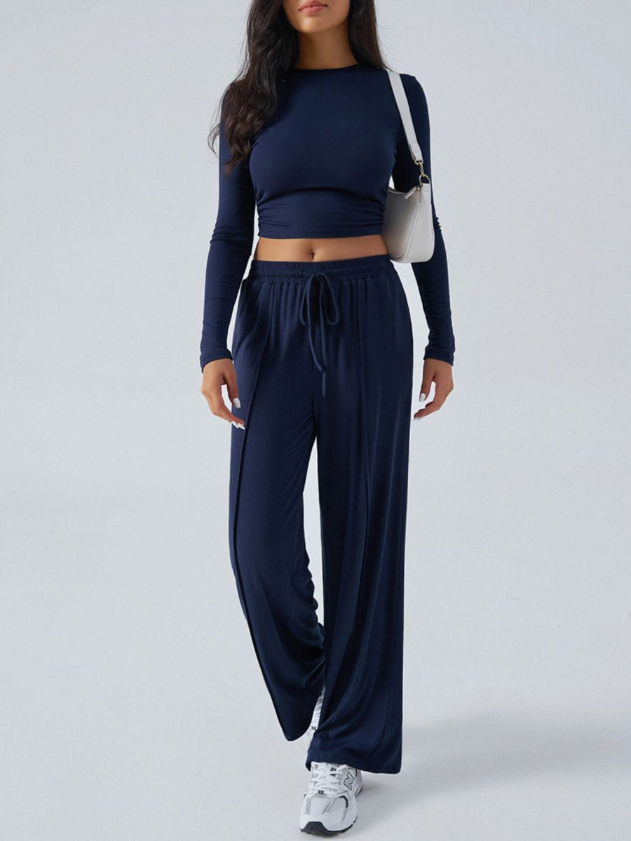 Dark blue ribbed knit crop top and wide leg pants set with drawstring waist.
