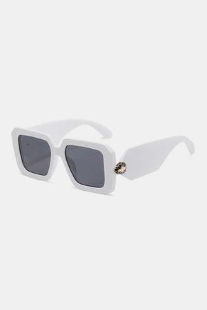 White geometric facet sunglasses with dark lenses and a jeweled embellishment on the arm.