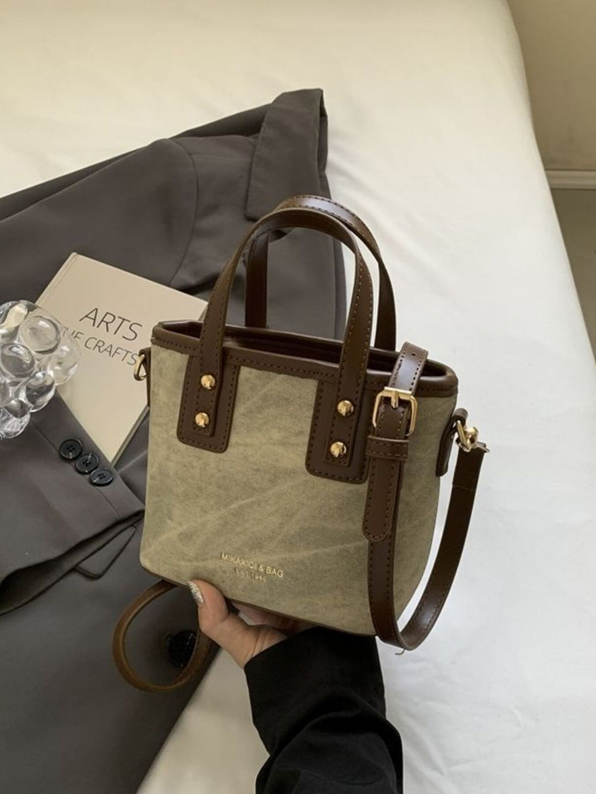 Premium mini chest bag in brown pu leather with adjustable strap and gold hardware