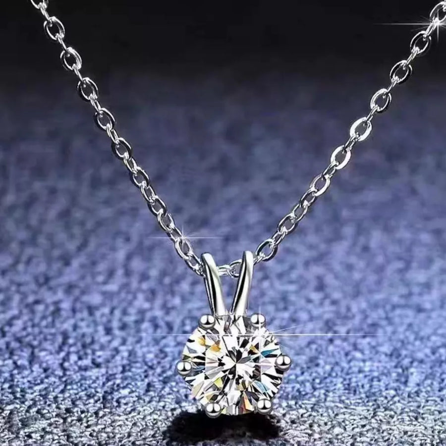 Elegant moissanite pendant necklace in sterling silver with a delicate chain.
