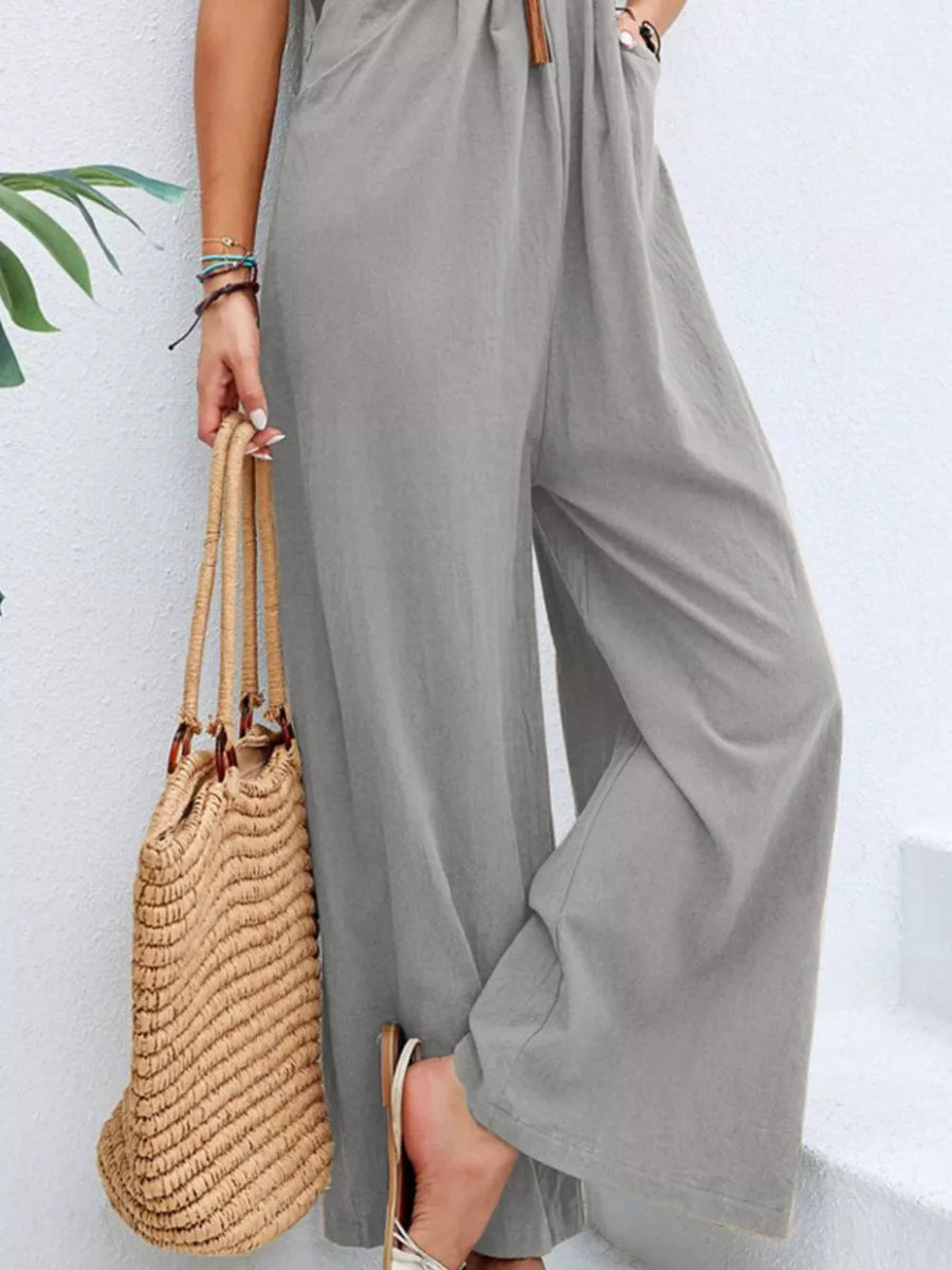 Light gray wide-leg romper with pockets and adjustable drawstring waist