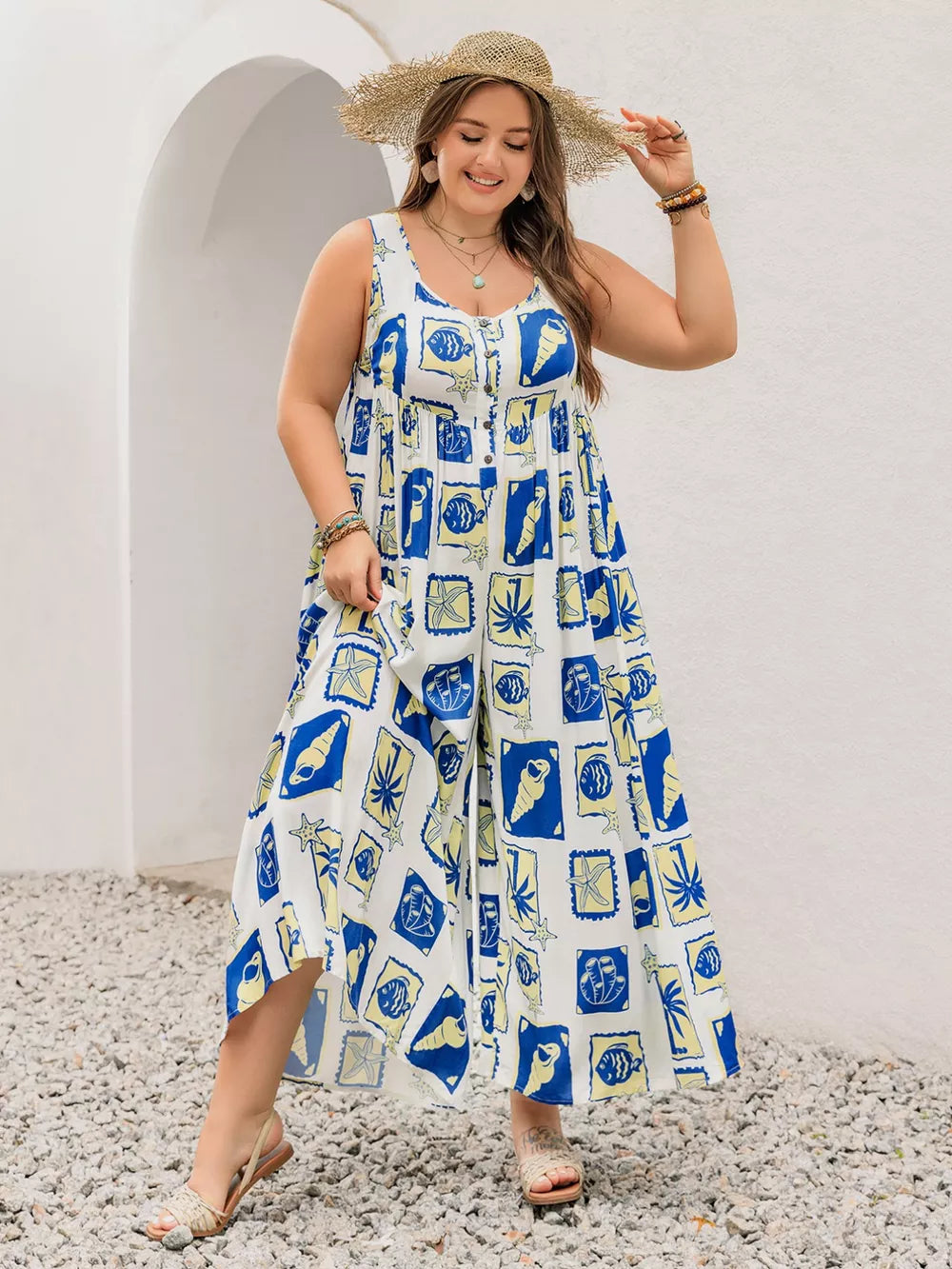 Plus-size relaxed jumpsuit with nautical print, V-neck, button front, and wide legs.