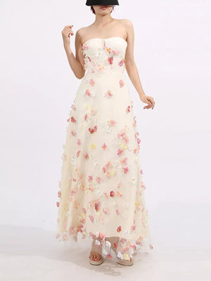 Strapless tulle maxi dress in ivory with colorful floral appliques and a sweetheart neckline.