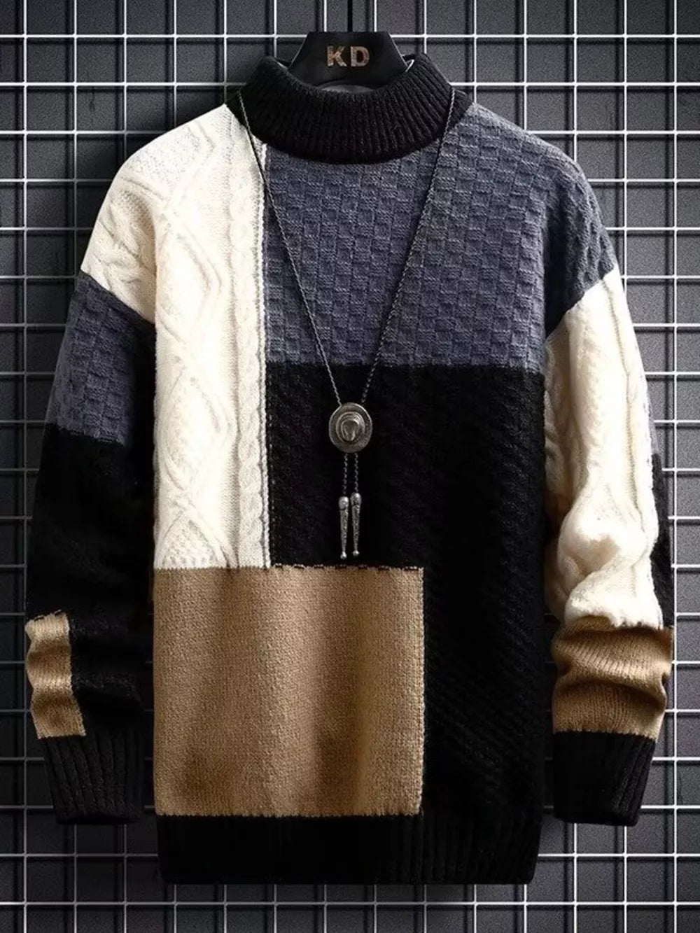 Men's multi-textured color block cable-knit turtleneck sweater in black, white, grey, and tan.