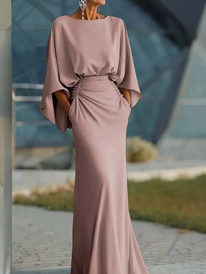 Sophisticated batwing sleeve maxi dress in pink with ruched waist and pockets.