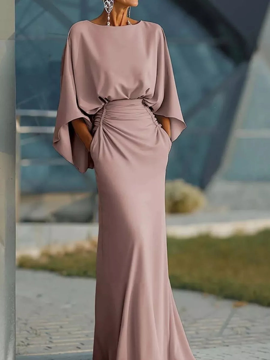 Sophisticated batwing sleeve maxi dress in pink with ruched waist and pockets.