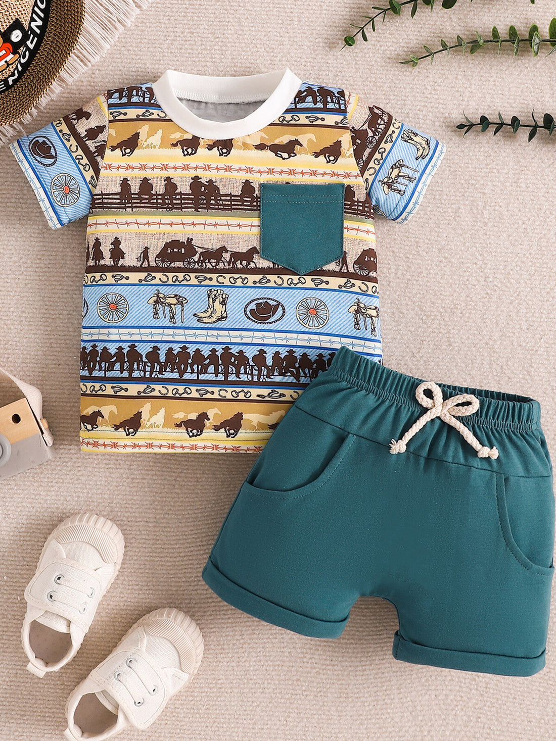 Children's western print tee with teal pocket and matching teal shorts with drawstring.