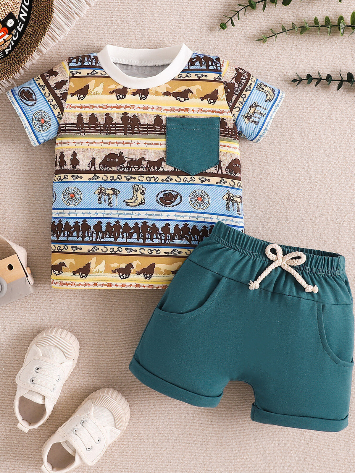 Children's western print tee with teal pocket and matching teal shorts with drawstring.
