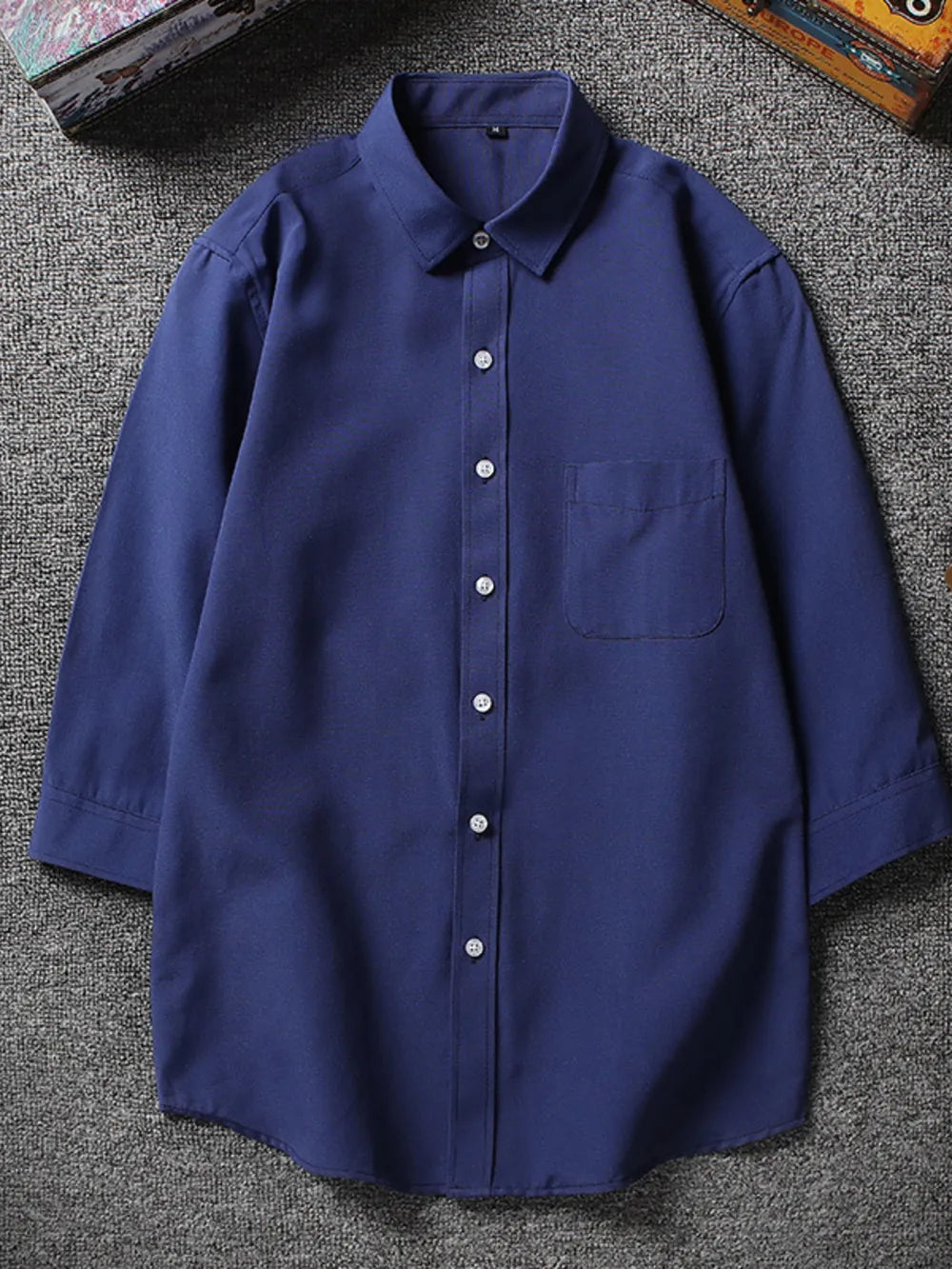 Navy blue button-up shirt with chest pocket and 3/4 sleeves