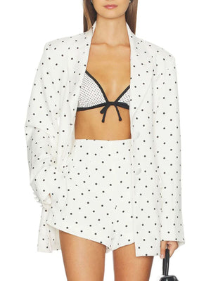 White blazer featuring buttoned and polka dot