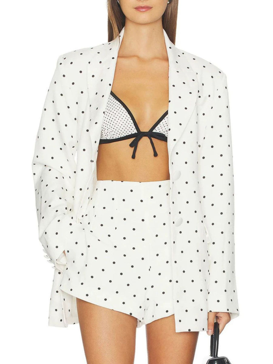 White blazer featuring buttoned and polka dot